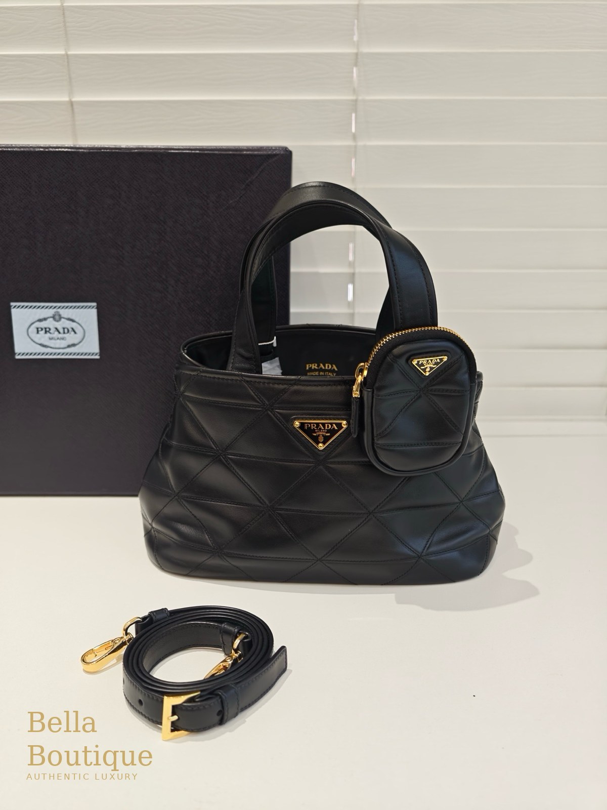شنطة Prada توت مبطّنة — سوداء أصلية — المنظر الأمامي مع الحزام والحقيبة الصغيرة